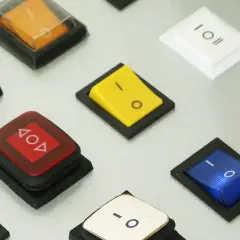 Bunte Schalter, wie dieser gelbe, zeigen, was ein Wippschalter ist: eine einfache Mechanik zum Ein- und Ausschalten.