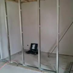 Metallständerwerk für Trockenbau, bereit für Elektroinstallation. Vorschriften werden beachtet. Werkzeug und Materialien liegen bereit.